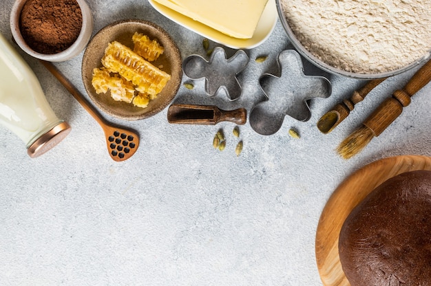 Christmas Baking background. Ingredients for cooking christmas baking on light background. Top view with copy space. Gingerbread cookies. Baking Ginger cookies. Raw dought for cookies