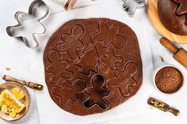 Christmas Baking background. Ingredients for cooking christmas baking on light background. Top view with copy space. Gingerbread cookies. Baking Ginger cookies. Raw dought for cookies