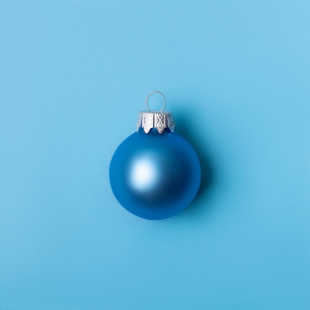 Christmas ball on blue background New Year greeting card with place for text