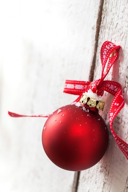 Christmas ball, christmas decoration hanging on a wooden wall, christmas concept, closeup with copy space