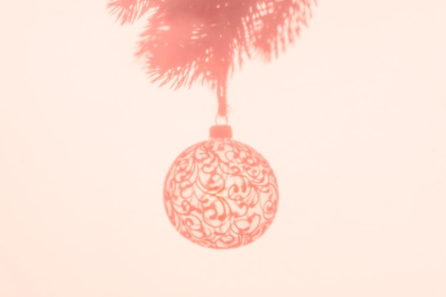 Christmas ball on Christmas tree creative photo new year christmas Color of the Year 2024 Peach Fuzz Selective focus