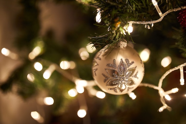 Christmas Ball On Christmas Tree with lights in a background, Merry Christmas and Happy New year