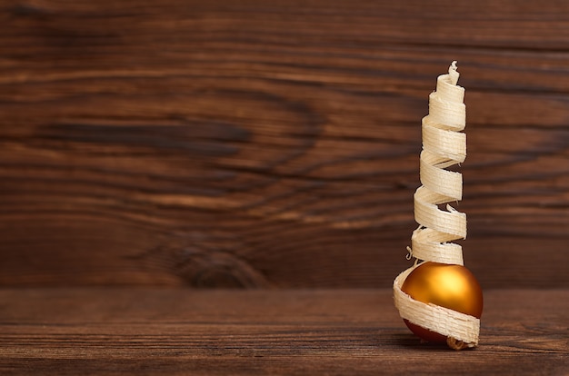 Christmas ball and Christmas tree on a wooden background