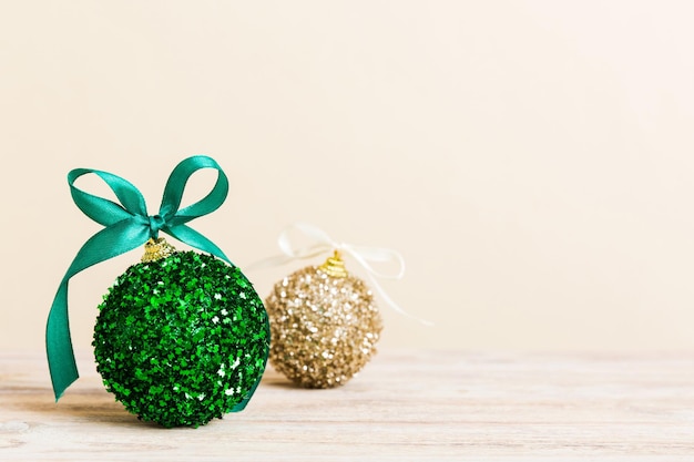 Christmas ball on colored background decoration bauble with ribbon bow with copy space