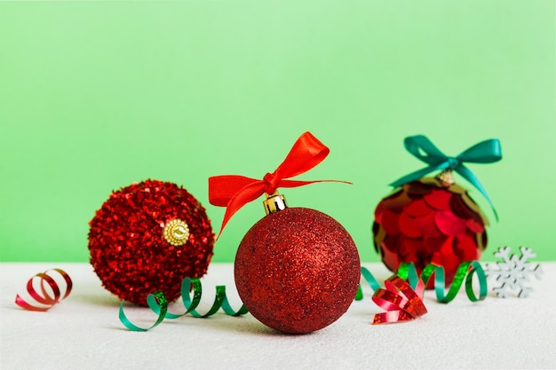 Christmas ball on colored background decoration bauble with ribbon bow with copy space