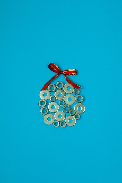 Christmas ball from washers and nuts on blue background