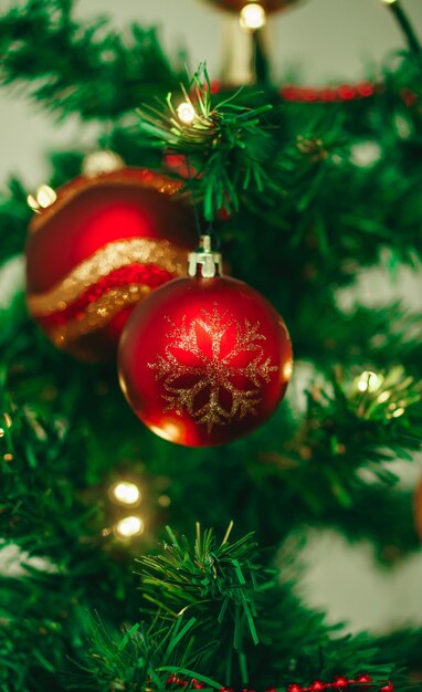 Christmas ball hanging on a fir branch along with other christmas decorations