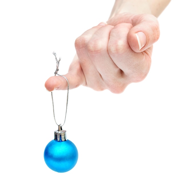 The Christmas ball hangs on the woman finger Isolated on white