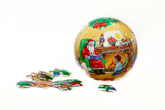 Christmas ball puzzle for decoration with Santa Claus isolated on white background.