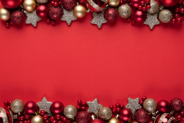 Christmas ball and red berries on red background