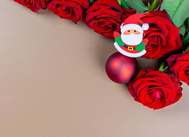 Christmas ball on red roses and santa close