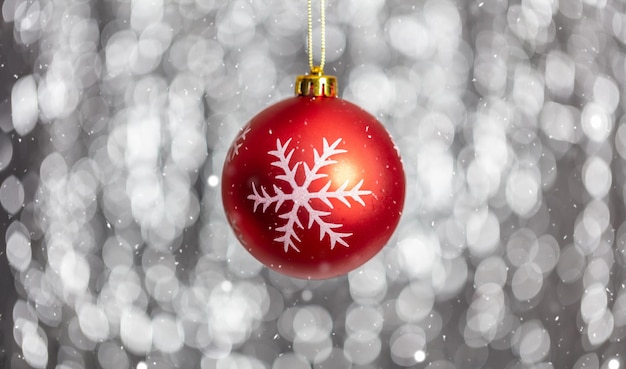 Christmas ball and snow in the night abstract bokeh lights background