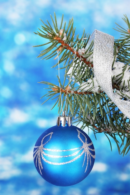 Christmas ball on the tree on blue