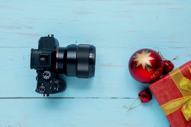 Christmas ball with digital camera on the table