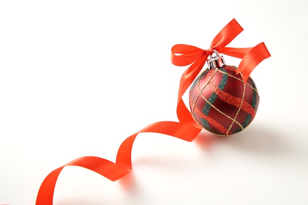 Christmas ball with red bow on white