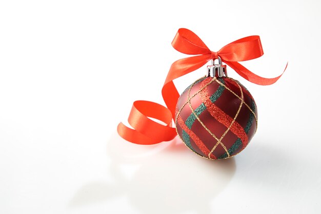 Christmas ball with red bow on white