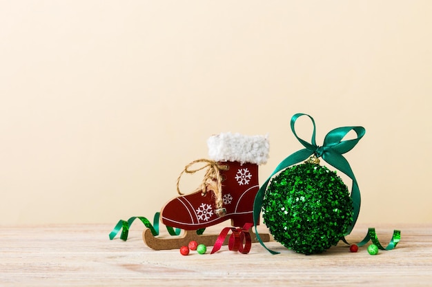 コピー スペースとリボン弓で色付きの背景装飾安物の宝石にスケート靴でクリスマス ボール