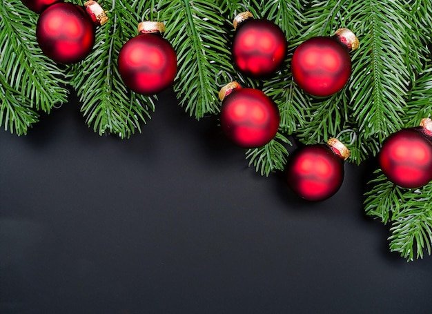 Christmas balls on branch of a tree on a black background