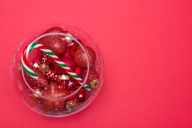 Christmas balls and candy cane in a round vase, top view