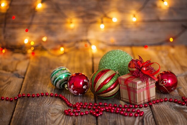 Christmas balls and Christmas gift on  wooden background