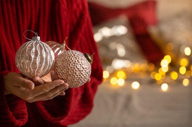 Christmas balls in female hands close up