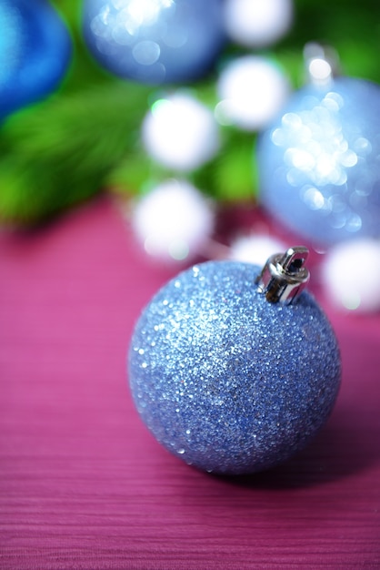 Christmas balls on fir tree, on color background