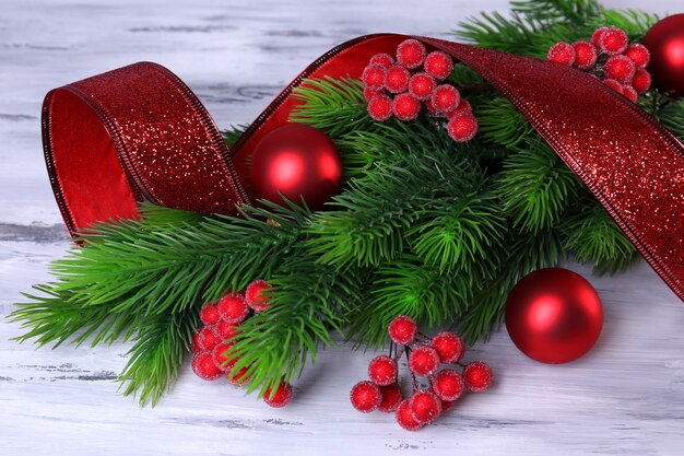 Christmas balls on fir tree, on wooden background