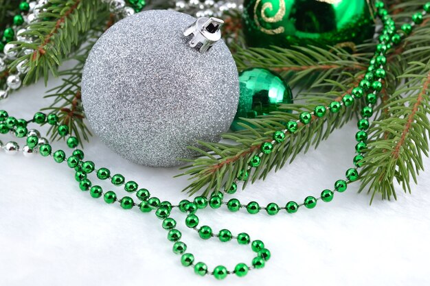 Christmas balls and garland on a spruce branch