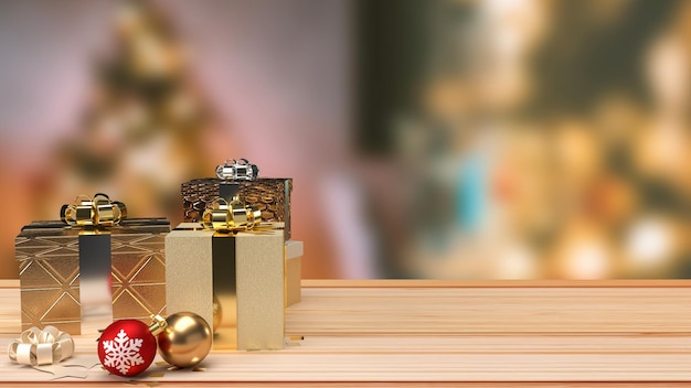 The Christmas balls and gift box on wood table for holiday concept