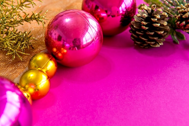 Christmas balls and ornaments on a pink background