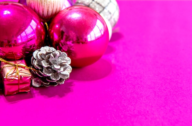 Christmas balls and ornaments on a pink background