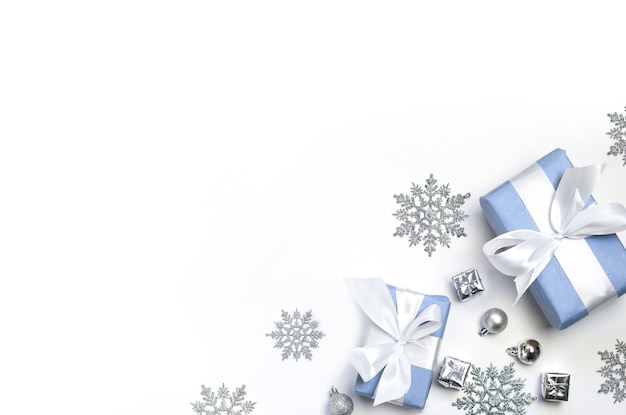 Christmas balls, silver decorations and two presents on a white background