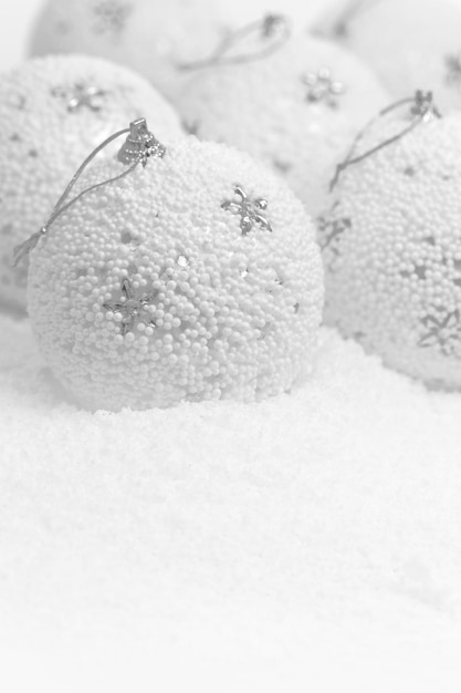 Christmas balls on white snowy background