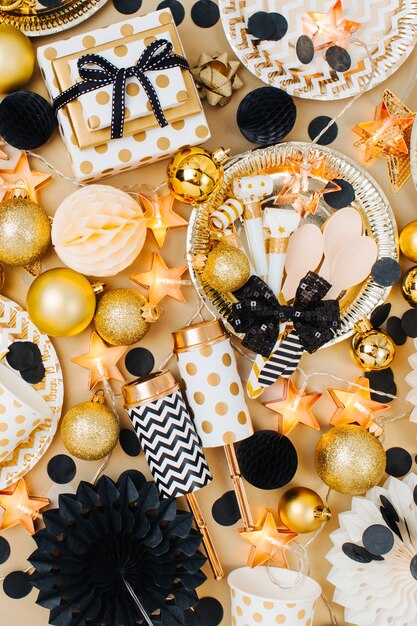 Christmas balls with decoration stuff in golden and black  colors.  Flat lay, top view