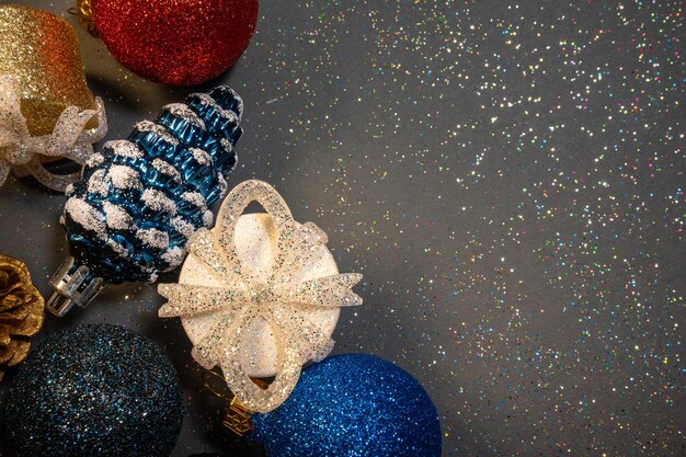 Christmas banner with Christmas decoration shiny balls pine cones gifts on a gray shiny backgroun