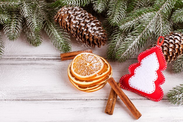 Christmas banner with green tree, cones, handmade felt decorations, orange and cinnamon