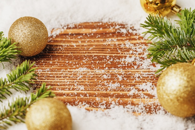 Christmas bauble on snowy wooden table. Christmas 