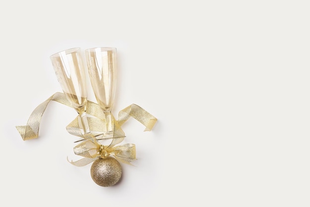 A christmas bauble tied with a gold bow