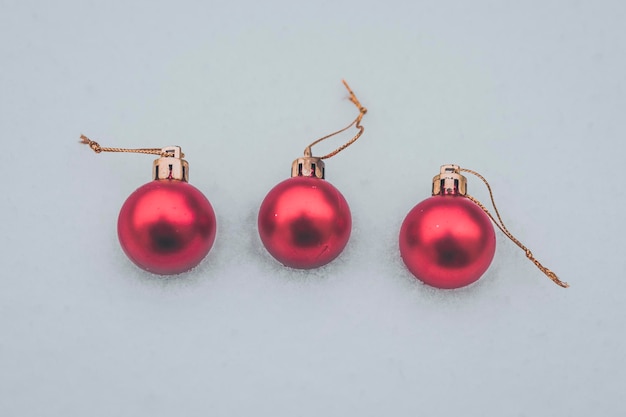 Christmas baubles in the snow three red baubles