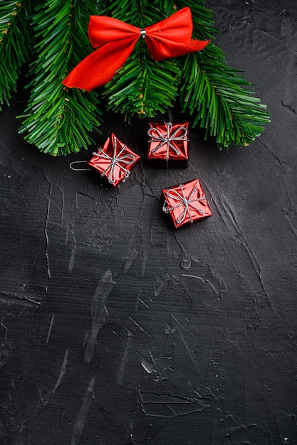 Christmas baubles and toys set, top view flat lay, on black dark stone table background, with copy space for text