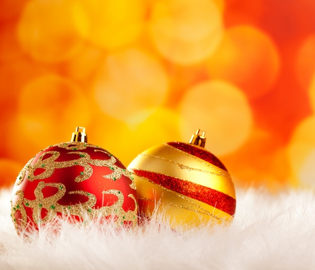 christmas baubles on white fur and lights