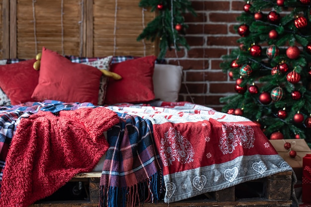 Christmas bedroom interior with redgreen colors with a christmas tree