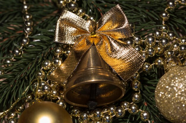 Christmas bell and tree decorations on the branches of the Christmas tree