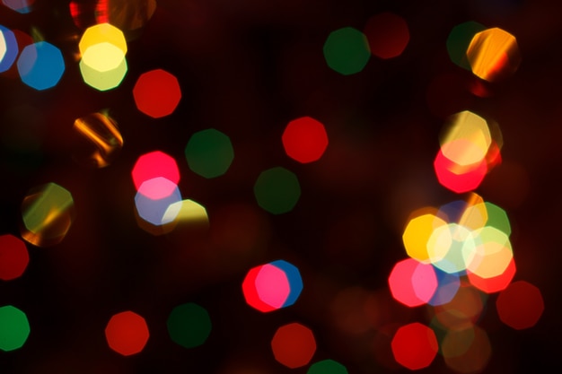 Christmas blurred background with colorful festive lights. Holiday night paty. Abstract circular bokeh background.