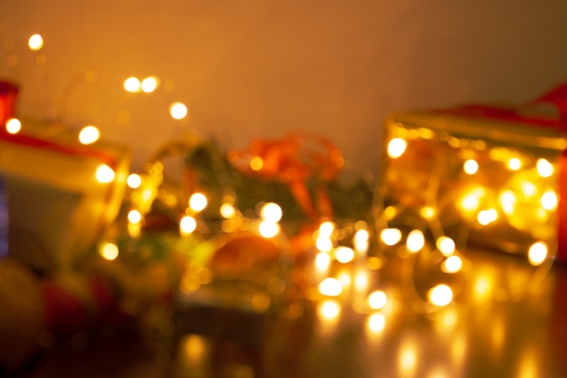 Christmas blurred background with gifts, ornaments and lights. Space for text.