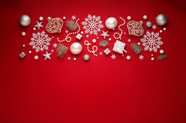 Christmas border of white decorations on red copy space background.