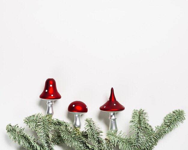 Christmas botanical ornaments fly agaric mushrooms with red cap and white dots on natural green