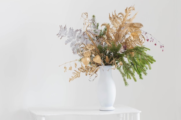 Christmas bouquet in white vase on white background