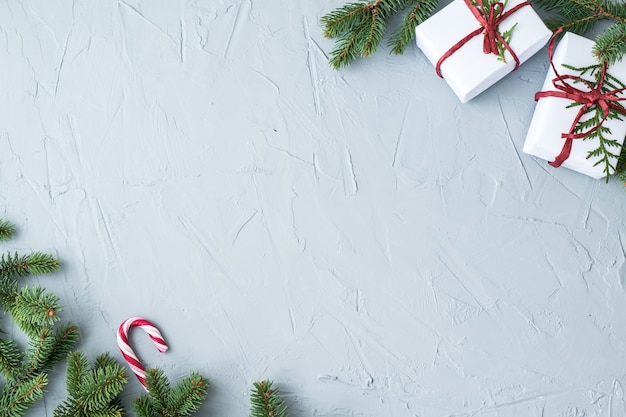 Christmas boxes and twigs on grey background