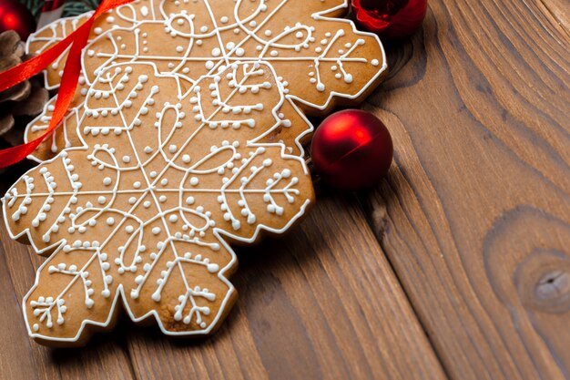 Christmas branch of fir tree decorated by gingerbread.